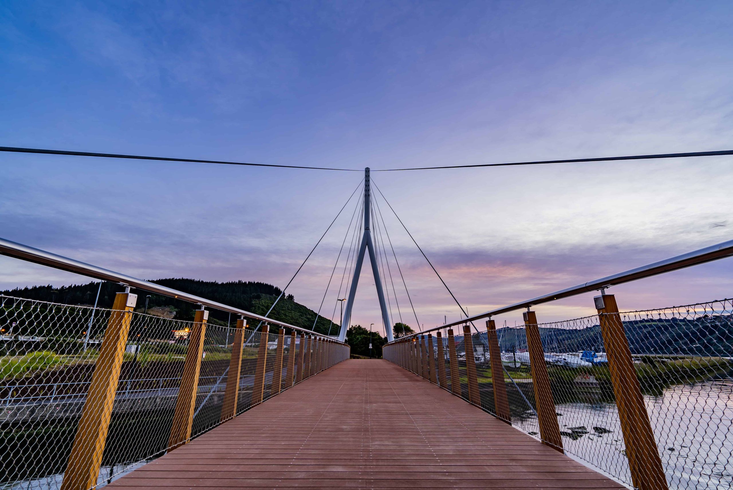Three workers on the manganui gorge suspension bridge
